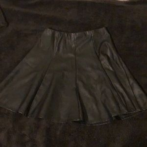 High -rise black leather imitation skirt.